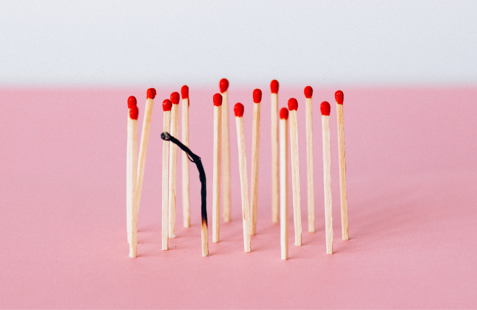 A group of matches with one burned out.